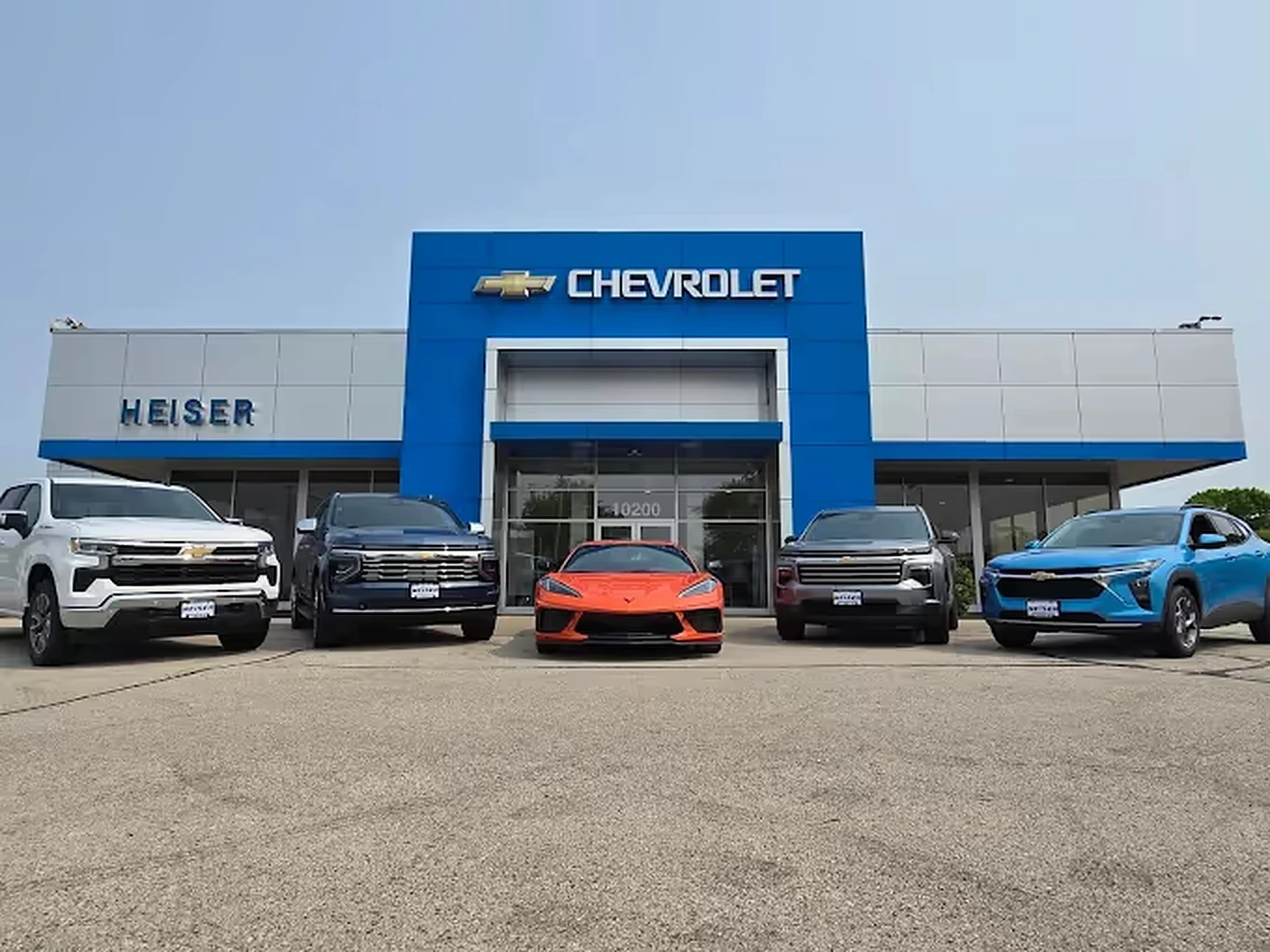 A line-up of vehicles on the lot outside a Chevrolet dealership
