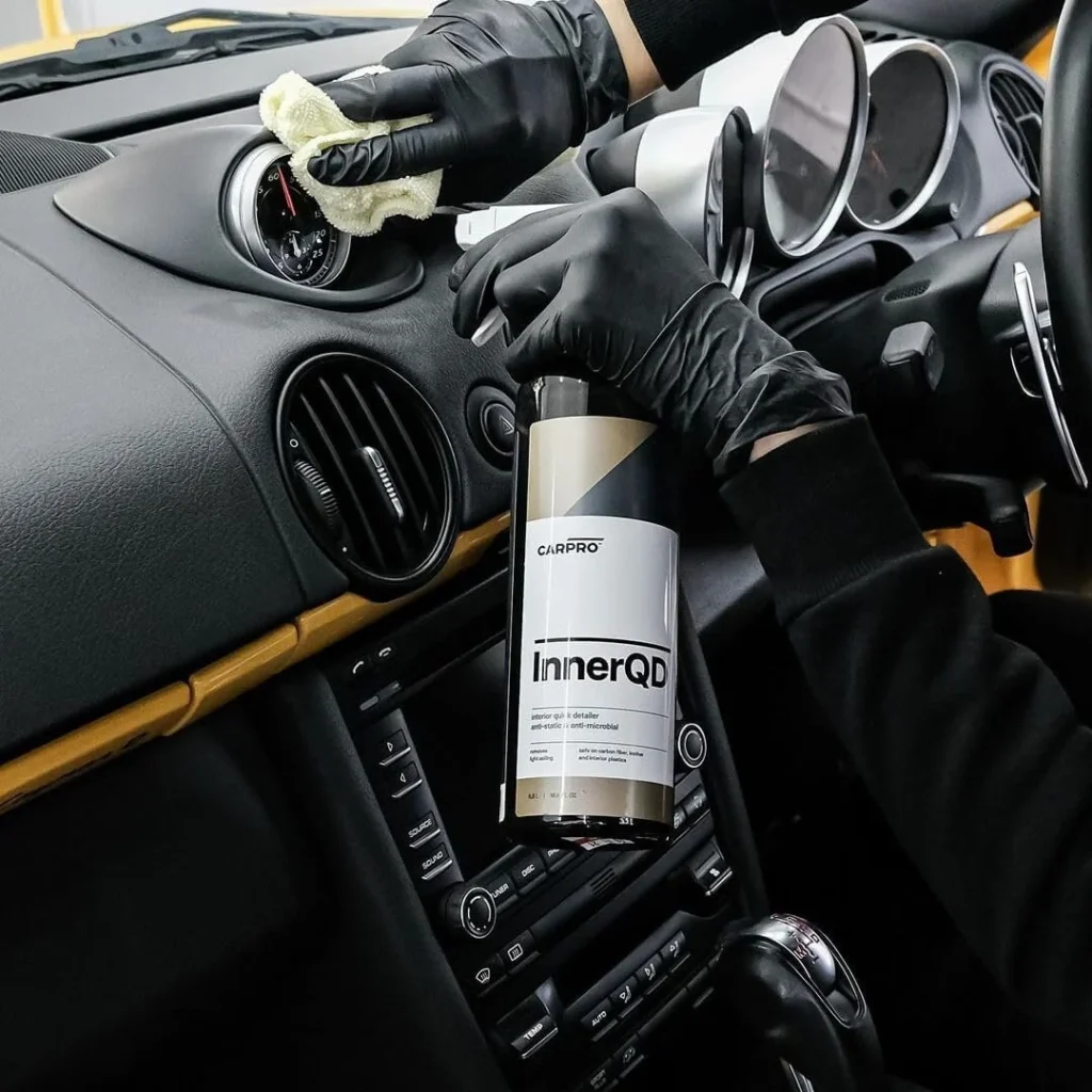 Detailer wiping down a dashboard